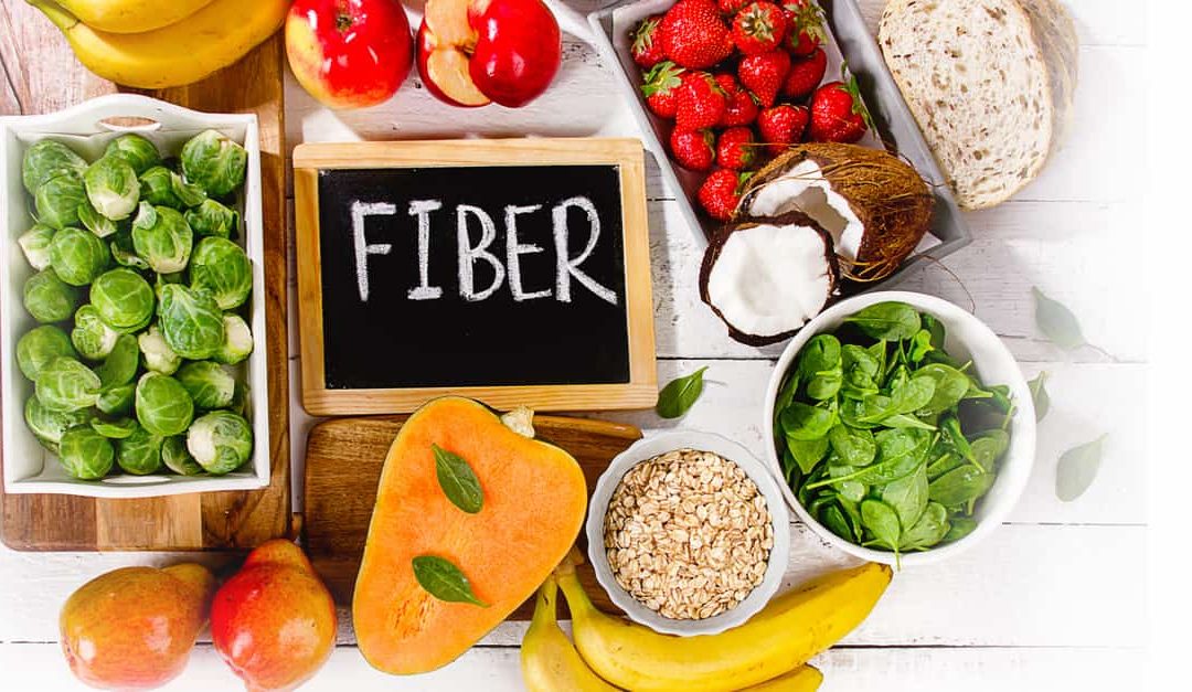 A selection of high fiber foods on a wooden background