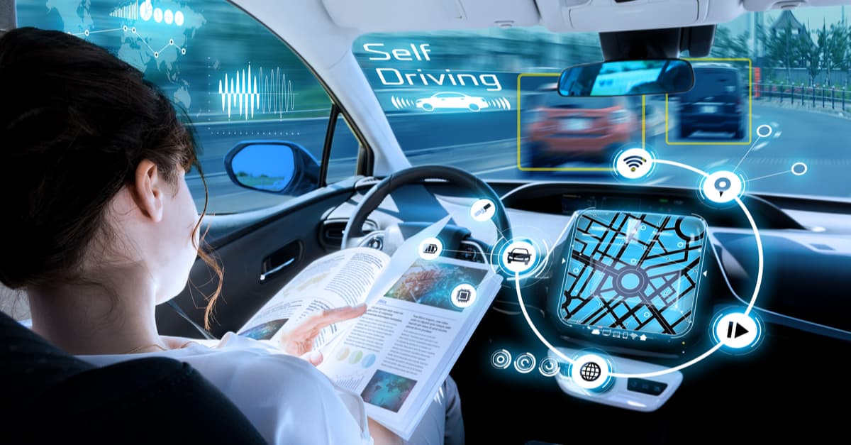 Driverless Cars Woman Sitting in a Self-Driving Car Reading a Book