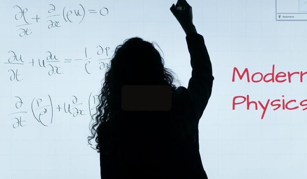 A lady writing on a white board with the words modern physics written in red lettering