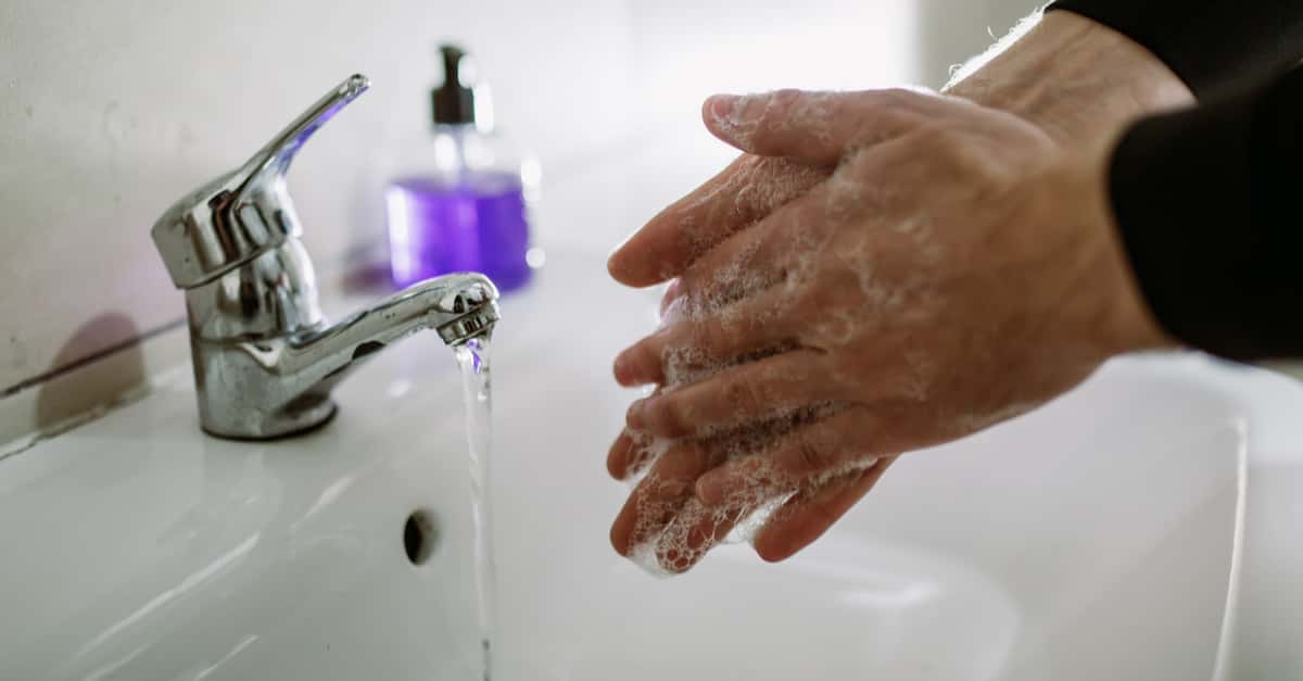 Man washing his hands with anti bacterial soap