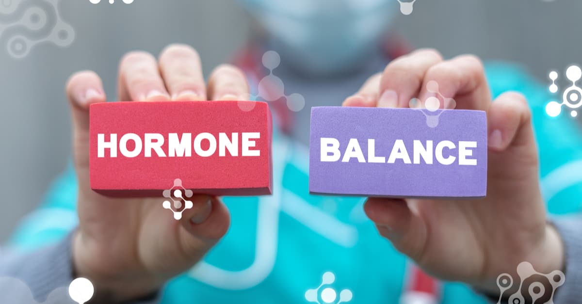 Nurse holding up two colored blocks stating 'hormone balance'